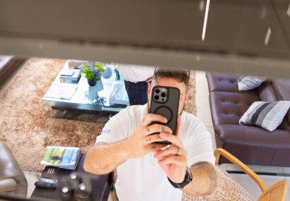 Man on an iphone looking up into a lift shaft.