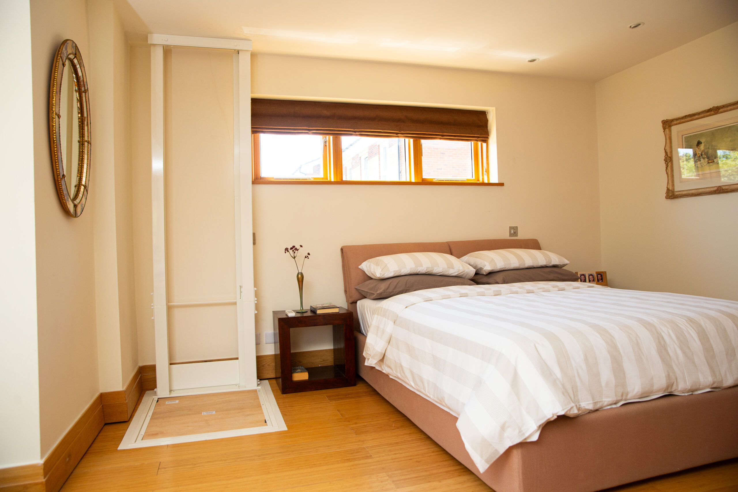 Affinity Home lift in down position in a bedroom setting. 