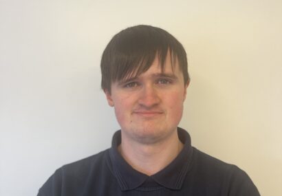 Headshot of a man in a Terry Lifts shirt